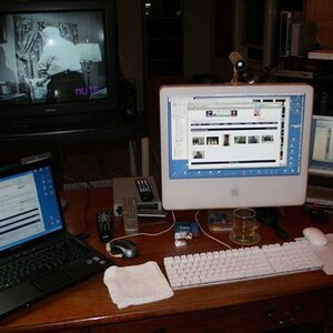 Command Central circa early 2008!

A Windows XP laptop (my travel 'throw away at the border' PC with no data) on the left, my iMac in the middle and