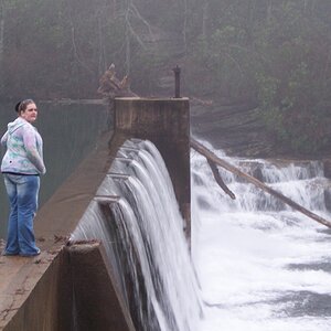 My daughter standing on the dam at DeSoto Falls.  The view from where she's standing is amazing.  Note the tree that fell into the river and got stuck