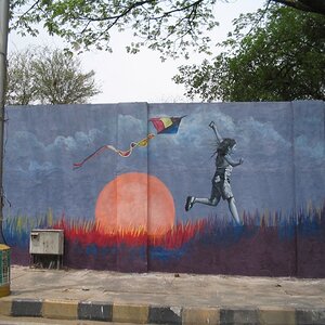 Paintings on wall - Girl flies kite as sun sets