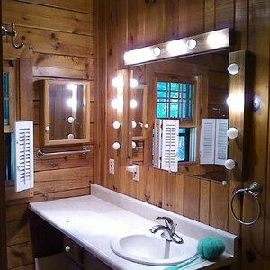 Bathroom vanity before. Those cheesy light fixtures included 14 little 25 watt bulbs, add it up and watch the meter spin when those lights were turned