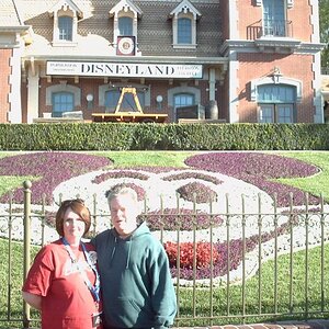Rosemary and Hersh in front of Mickey flowers at Disneyland